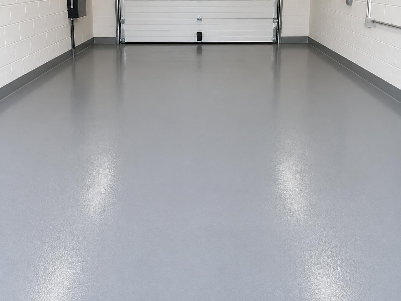 Domestic garage floor after renovation, finished in a smooth grey resin coating